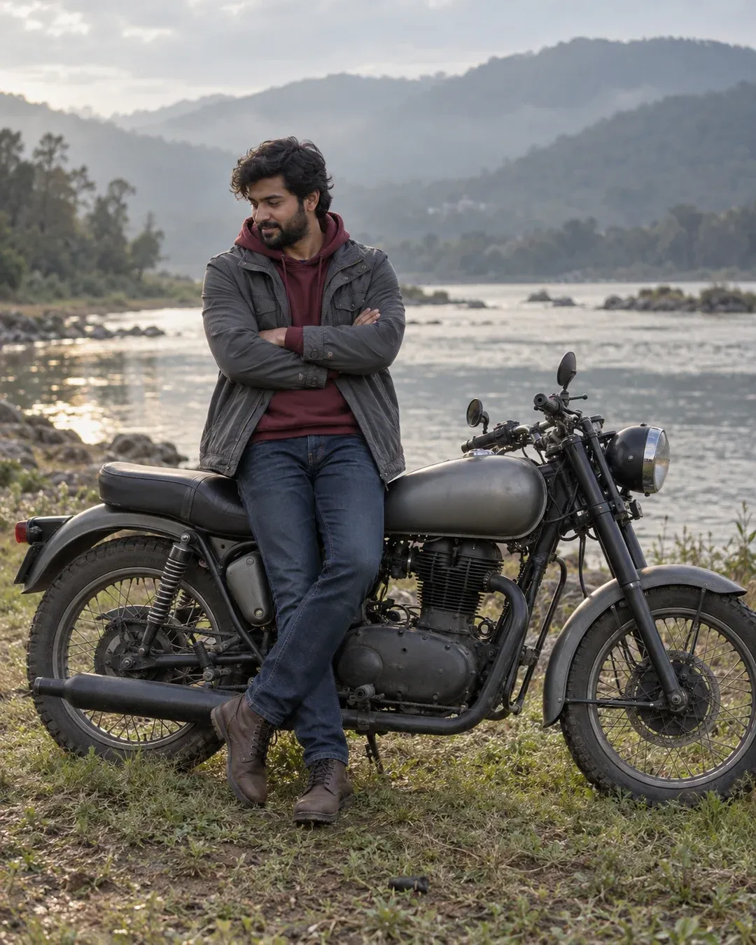 Example result: A young man in a grey parka leans on a classic matte grey motorcycle on a grassy riverbank, looking down.